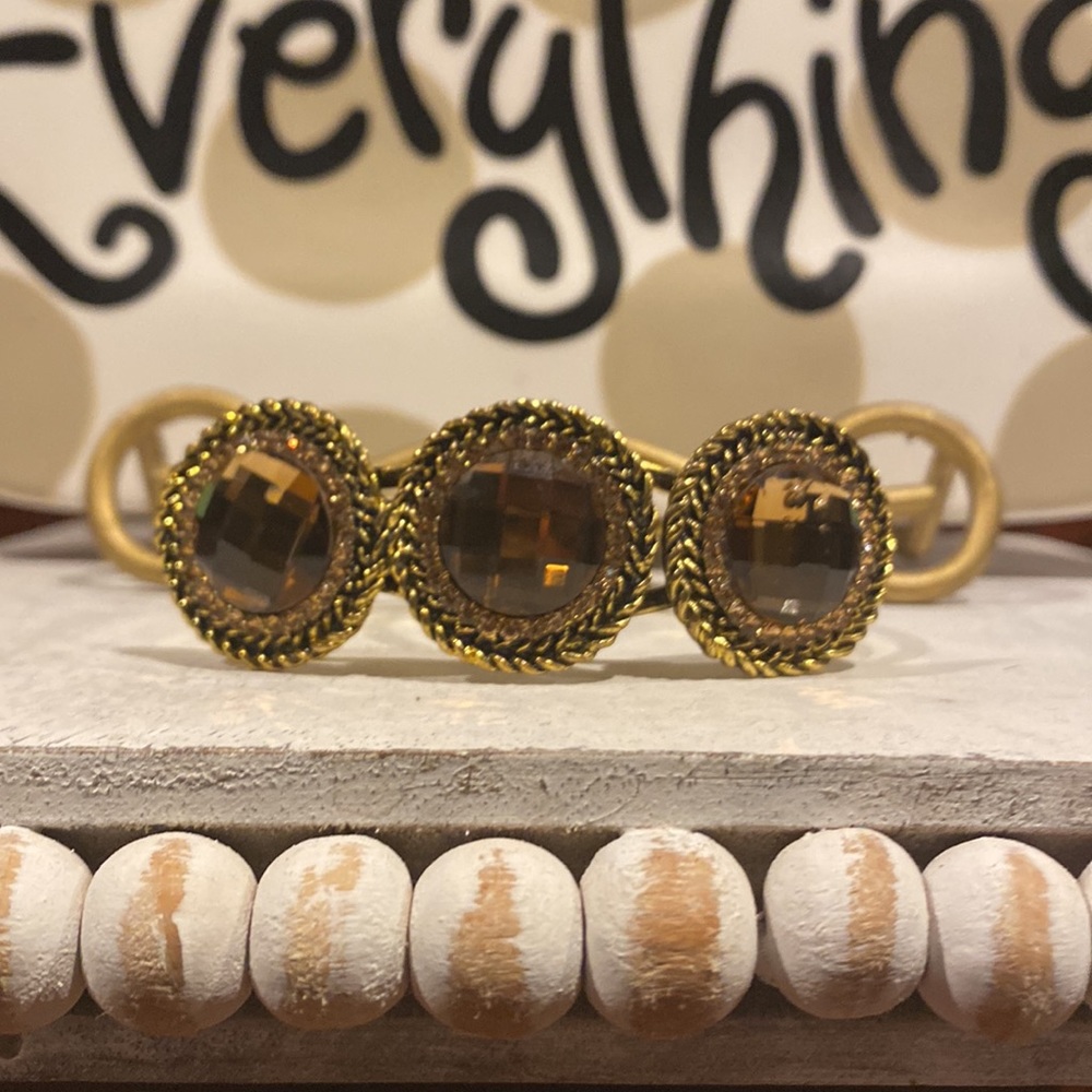 Beautiful bracelet with three gold gemstones. Hinged opening is easy to use.